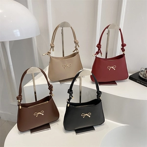 Minimalist leather shoulder bags with bow hardware in beige, red, brown, and black