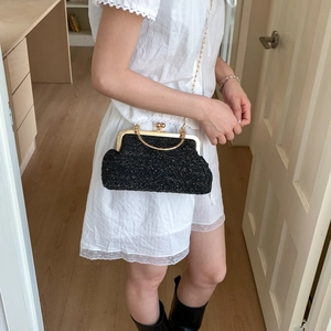 Elegant black tweed evening handbag with gold metal handle and chain shoulder strap