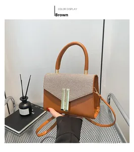 Detailed view of brown crossbody bag with woven texture lid and elegant gold lock