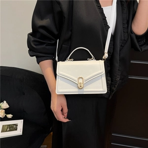 White leather crossbody square bag with gold oval twist lock and adjustable shoulder strap