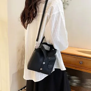 Minimalist black shirt-collar design crossbody bag with silver buttons and side pocket