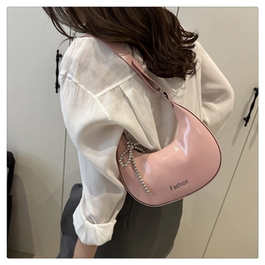 Pink patent leather dumpling bag with silver bead bow charm and Fashion print detail