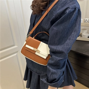 Stylish two-tone brown and beige Kelly bag with gold buckle and adjustable strap