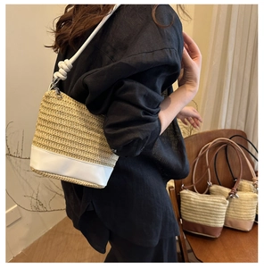 Detail of woven straw bucket bag with white leather trim and unique knotted shoulder strap