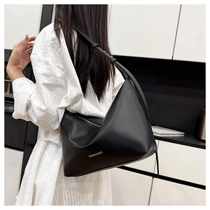 Detail view of the soft matte black leather hobo bag with gold fashion lettering