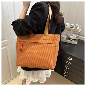 Orange-brown woven tote bag with large capacity and shoulder straps for daily use