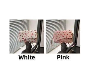 Detail of minimalist crescent bags with cherry print in white and pink color options