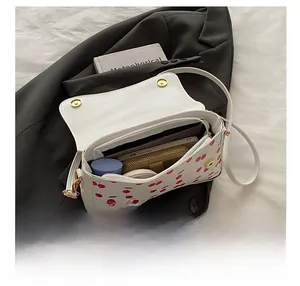 Interior view showing the large capacity of the white cherry print crossbody bag