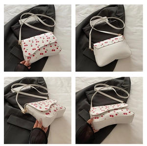 Detailed four-way view showing sweet cherry print on white crescent moon shoulder bag