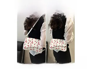 Detailed views of a white cherry print crossbody phone bag showing single shoulder and crossbody wear