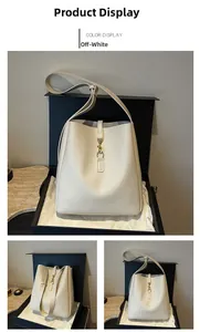 Detailed view of off-white leather bucket bag with golden metal hook and matching gift box