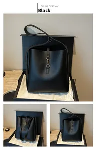 Detail view of black soft leather bucket bag with metal hook and fabric lining