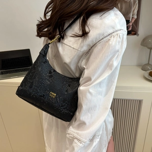 Minimalist black snakeskin textured hobo bag with gold metal hardware and brand lettering