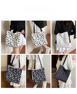 Detail view of large canvas tote bag showing floral and polka dot patterns with straps