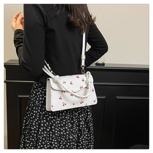 Chic white rectangle crossbody bag with red cherry prints and adjustable shoulder strap
