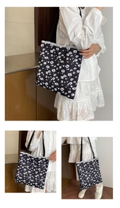 Detail of floral canvas tote bag featuring delicate white lace trim and daisy patterns