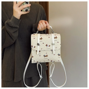Detail of mini backpack featuring cute dachshund prints and adjustable shoulder straps