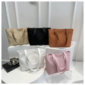 Group shot of five corduroy tote bags in beige, black, brown, white, and pink