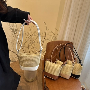 Minimalist hand-woven straw shoulder bag with leather contrast stitching and rope straps