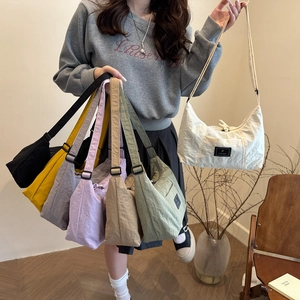 Minimalist nylon crescent crossbody tote bags shown in seven versatile colors and styles