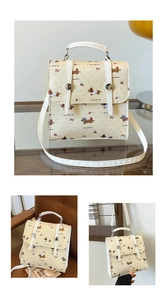 Detail view of mini dachshund print satchel bag with retro hardware and cherry patterns