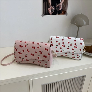 Chic women's crossbody bags in pink and white with sweet red cherry prints and gold buckles