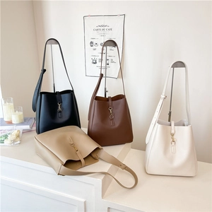 Minimalist PU leather bucket bags in black, brown, and cream with vintage metal buckles