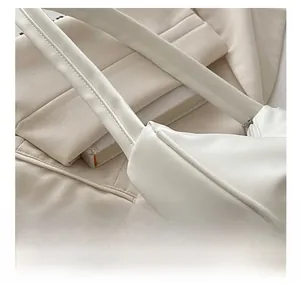 Close-up of premium white pleated shoulder bag with silver hardware and fine stitching