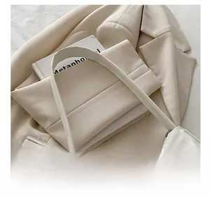 Detail showing the comfortable shoulder strap and smooth zipper of the white leather bag