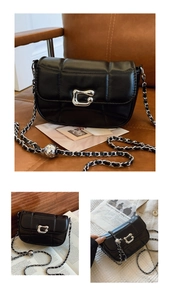 Close-up of black quilted bag with C-shaped silver buckle and leather chain strap