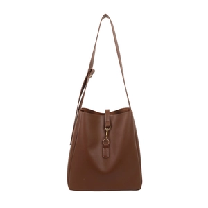 Minimalist dark brown leather bucket bag with adjustable shoulder strap and gold hardware