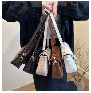 Detailed display of vintage underarm bags in five colors with glossy texture and gold hardware