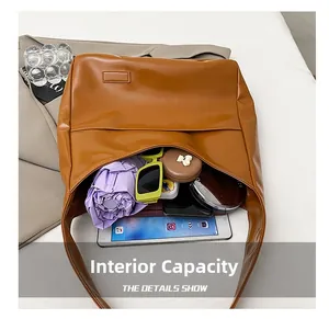 Detail showing the large internal capacity of the brown tote bag for daily essentials
