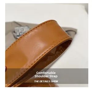 Close-up of a comfortable brown shoulder strap with reinforced stitching on a tote bag