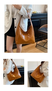 Detail of caramel high-gloss leather tote bag showing reflective finish and wide strap