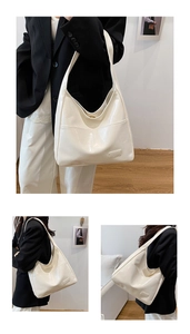 Macro view of high-gloss white PU leather texture and rectangle detail on hobo bag