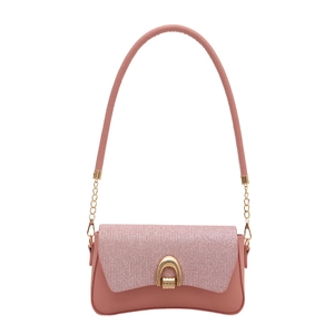 Chic pink glitter shoulder bag with a gold horseshoe buckle and elegant chain strap