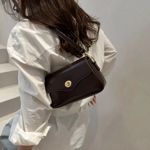 Vintage dark brown matte leather underarm bag with a golden metallic twist lock