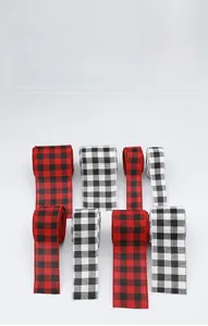 Detail of red and black buffalo plaid Christmas ribbons with various widths and edges