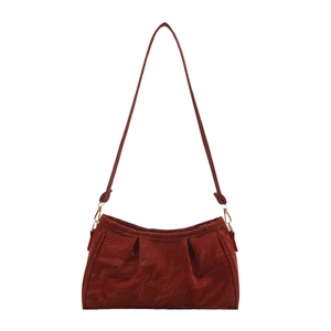 Deep red pleated underarm cloud bag with fine shoulder strap and gold hardware