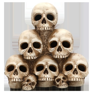Detailed view of stacked resin skulls pyramid for Halloween haunt house decoration