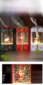 Close-up of Christmas gift box lanterns featuring Santa, snowman, and shimmering LED snow