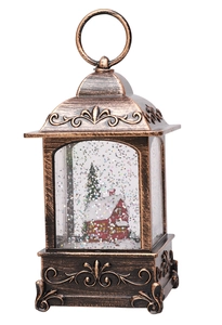 Detail of bronze Christmas snow globe lantern with house scene and swirling glitter