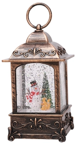 Detail of vintage Christmas lantern featuring a snowman scene and swirling silver glitter