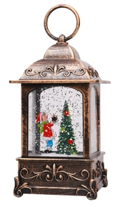 Detail of vintage bronze Christmas lantern with Santa decorating tree inside and glitter