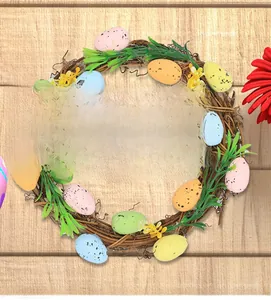 Detailed view of colorful speckled Easter eggs and green leaves on a natural rattan wreath