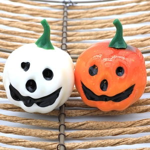 Halloween foam pumpkin decorations in orange and white with smiling Jack-o'-lantern faces