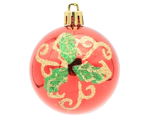 Detail view of a red Christmas ball ornament with gold and green glitter vine patterns