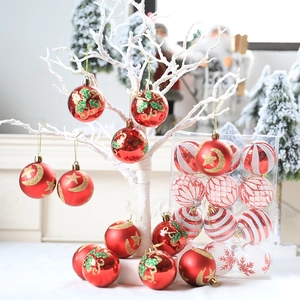 Set of decorative red and white Christmas balls with glitter patterns on a white festive tree