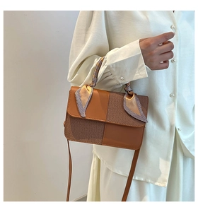 Detail of diagonal color-block crossbody bag with herringbone fabric and silk scarf handle